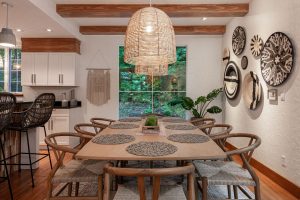 Dining room with wishbone chairs, rattan pendants and woven wall baskets