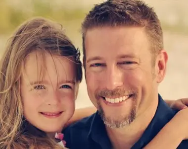 Portrait of Doug Stratton and his daughter smiling