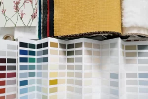 A variety of fabric swatches alongside a detailed color palette for design inspiration.
