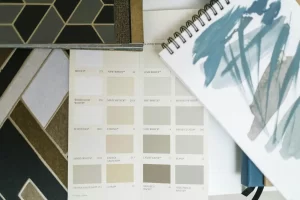 Top view of color swatches and design notebook showcasing elegant interior design elements.