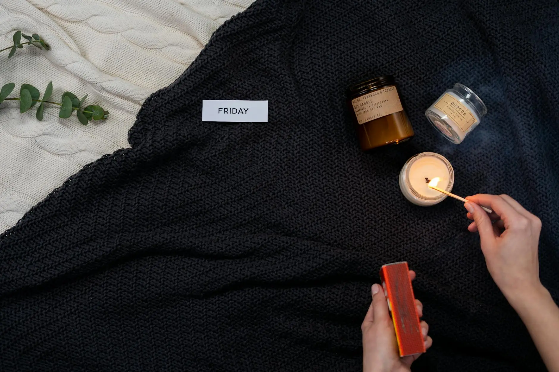 A serene setup with candles and blanket, evoking calm and relaxation.