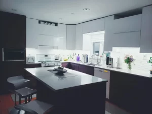 Contemporary kitchen interior with sleek white cabinets and island, perfect for a minimalist aesthetic.